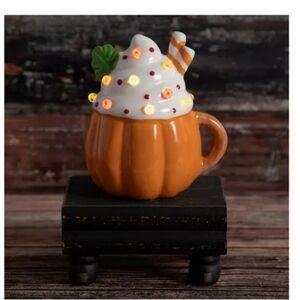 FALL PUMPKIN MUG LIGHT UP.  CERAMIC MUG WITH A SWIRL OF WHIPPED CREAM ON TOP.